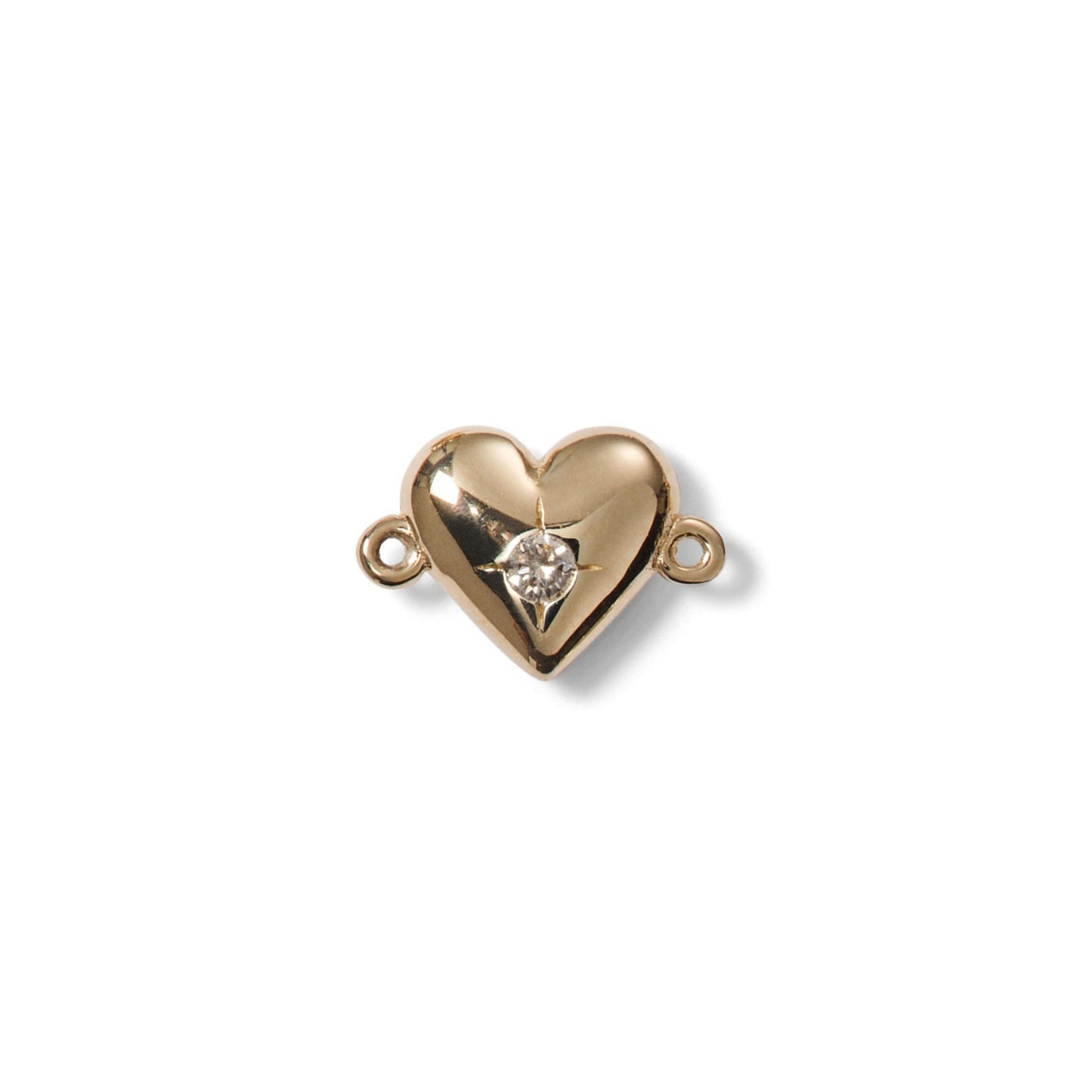 Gold heart-shaped jewelry clasp with a diamond on a white background