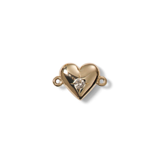 Gold heart-shaped jewelry clasp with a diamond on a white background